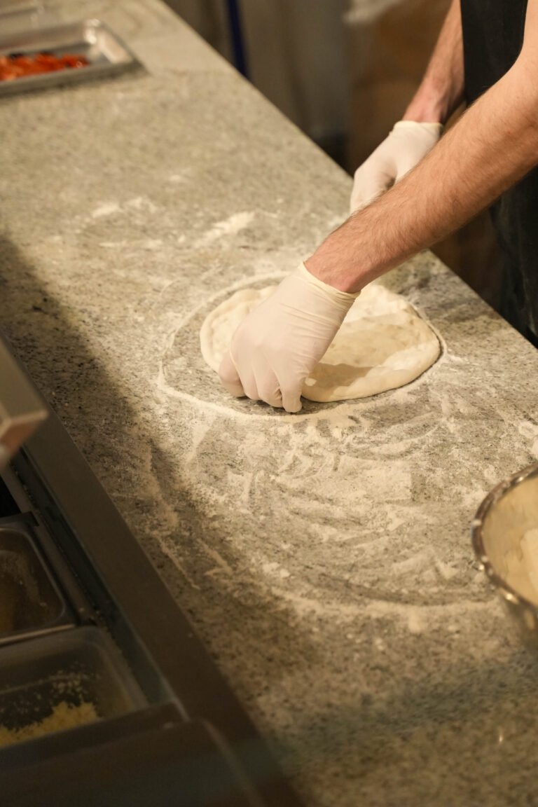 Black Dog Pizza cook shaping pizza dough by hand